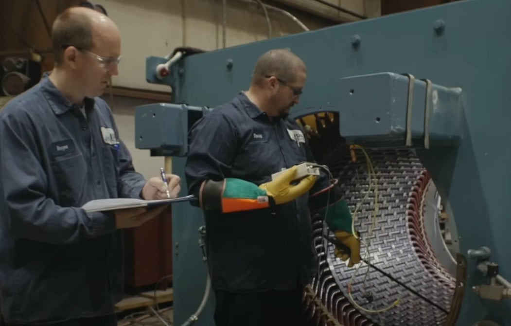 2 IPS workers performing maintenance on electrical coils