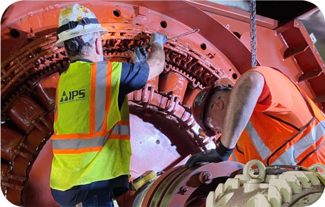 IPS workers performing maintenance on an industrial machine
