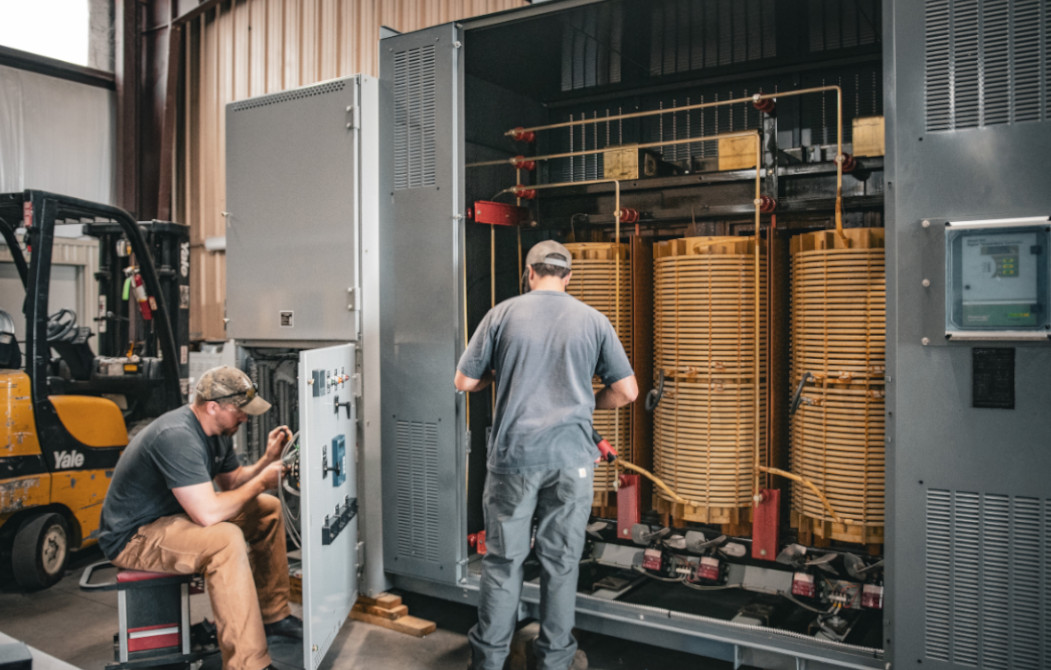 Two IPS employees working at a substation
